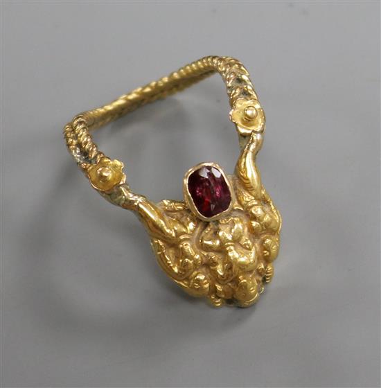 An Indian 22c and gem set deity upfinger ring, size K.